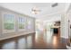Open concept living room with hardwood floors and a seamless flow into the kitchen area at 830 Nottingham Se Dr, Smyrna, GA 30082