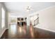 Open concept living room with hardwood floors and a seamless flow into the kitchen area at 830 Nottingham Se Dr, Smyrna, GA 30082