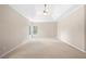 A neutral-toned main bedroom featuring a ceiling fan, carpet flooring, and natural light at 830 Nottingham Se Dr, Smyrna, GA 30082