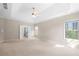 Bright main bedroom offering tray ceiling, ceiling fan, carpet flooring, and en suite bathroom at 830 Nottingham Se Dr, Smyrna, GA 30082