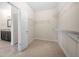 Walk-in closet with installed shelving next to en suite bathroom at 830 Nottingham Se Dr, Smyrna, GA 30082