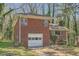 Charming brick home featuring an attached garage and mature trees in a serene setting at 195 Hermer Nw Cir, Atlanta, GA 30311