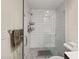 The tiled walk-in shower is equipped with multiple shower heads, built-in shelves, and a clear glass door at 3021 San Juan Dr, Decatur, GA 30032