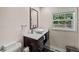 Stylish bathroom featuring a modern vanity with a vessel sink, window, and dark wood cabinets at 3021 San Juan Dr, Decatur, GA 30032