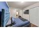 Stylish primary bedroom features a blue accent wall, closet space, hardwood flooring, and an ensuite bathroom at 3021 San Juan Dr, Decatur, GA 30032