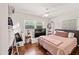 Bedroom features a comfortable bed, a ceiling fan, natural light and an accent mirror for added appeal at 3021 San Juan Dr, Decatur, GA 30032