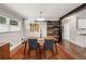 Dining room featuring a wooden table, an area rug, a modern light, and a wooden sliding barn door at 3021 San Juan Dr, Decatur, GA 30032