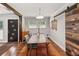 Dining area with wood floors, a wood sliding barn door, and a modern light fixture at 3021 San Juan Dr, Decatur, GA 30032