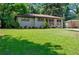 Attractive one-story home featuring a well-maintained lawn, tidy landscaping, and gray brick facade at 3021 San Juan Dr, Decatur, GA 30032