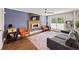 Cozy living room with hardwood floors, a gray sofa, a fireplace, and stylish decor at 3021 San Juan Dr, Decatur, GA 30032