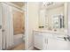 Bright bathroom featuring white cabinets, a marble countertop, and tiled shower with bathtub at 4105 Brookview Dr, Cumming, GA 30040