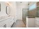 Bright bathroom featuring a double vanity, decorative mirrors, and a glass-enclosed shower at 4105 Brookview Dr, Cumming, GA 30040