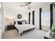 Modern bedroom with a queen bed, dark furniture, and bright natural light at 4105 Brookview Dr, Cumming, GA 30040