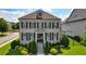 Charming two-story brick home featuring a symmetrical design, lush landscaping, and a welcoming front entrance at 4105 Brookview Dr, Cumming, GA 30040