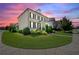 Beautiful two-story brick home with black shutters, landscaped yard, and a vibrant sunset backdrop at 4105 Brookview Dr, Cumming, GA 30040