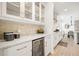 Kitchen includes a wine fridge, white cabinets, stone backsplash, and modern appliances at 4105 Brookview Dr, Cumming, GA 30040