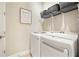 Functional laundry room featuring modern washer and dryer units with overhead shelving at 4105 Brookview Dr, Cumming, GA 30040