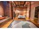 Loft-style bedroom with exposed brick, wood flooring, large rug, and industrial-chic decor at 490 Marietta Nw St # 101, Atlanta, GA 30313
