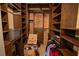 Walk-in closet with custom shelving and storage solutions; exposed brick in the back adds a unique touch at 490 Marietta Nw St # 101, Atlanta, GA 30313