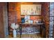 Cozy coffee bar area featuring a brick wall, coffee maker, snacks and appealing artwork at 490 Marietta Nw St # 101, Atlanta, GA 30313