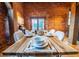 Inviting dining area showcasing a wooden table set for a meal, in a space with brick walls and beams at 490 Marietta Nw St # 101, Atlanta, GA 30313