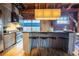 Kitchen with wooden floors, an island with seating, stainless steel appliances, and exposed brick walls at 490 Marietta Nw St # 101, Atlanta, GA 30313