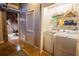 Convenient laundry area with modern washer and dryer units, storage shelves and a view into an office area at 490 Marietta Nw St # 101, Atlanta, GA 30313