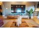 Cozy living room featuring hardwood floors, a large TV, and a stylish entertainment center, perfect for relaxation and entertainment at 490 Marietta Nw St # 101, Atlanta, GA 30313