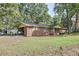 Ranch-style brick home with a carport and front porch surrounded by mature trees at 1189 E East Fayetteville Rd, Riverdale, GA 30296