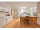 Bright kitchen featuring white cabinets, hardwood flooring, and a breakfast bar with seating at 1189 E East Fayetteville Rd, Riverdale, GA 30296