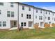 Backyards featuring green grass, privacy fencing, and modern white townhome siding at 3135 Washburn St, Atlanta, GA 30354