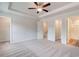 Bright bedroom includes plush carpeting, a ceiling fan, and three doors to closets and the bathroom at 3135 Washburn St, Atlanta, GA 30354