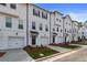 Row of townhomes featuring garages, multiple windows, and landscaped front yards at 3135 Washburn St, Atlanta, GA 30354