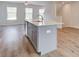 Grey kitchen island with white countertop and stainless steel sink in open living space at 3135 Washburn St, Atlanta, GA 30354