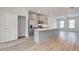 Modern kitchen with stainless steel appliances, island, and wood-look vinyl flooring at 3135 Washburn St, Atlanta, GA 30354