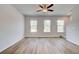 Spacious living room featuring wood look vinyl floors, ceiling fan, and lots of natural light at 3135 Washburn St, Atlanta, GA 30354
