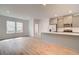 Open-concept living area with hardwood floors connecting the kitchen and living spaces at 3135 Washburn St, Atlanta, GA 30354