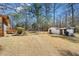 Picturesque backyard featuring a detached shed, screened porch, and well-manicured lawn with mature trees at 4562 Anderson Livsey Ln, Snellville, GA 30039