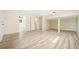 Open basement featuring wood-look laminate flooring, neutral paint, and ample space for various uses at 4562 Anderson Livsey Ln, Snellville, GA 30039