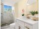 Stylish bathroom features a glass enclosed shower, white vanity, gold fixtures, and modern accents at 4562 Anderson Livsey Ln, Snellville, GA 30039