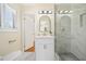 Updated bathroom features marble tile, a glass enclosed shower and updated vanity with gold hardware at 4562 Anderson Livsey Ln, Snellville, GA 30039