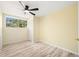 Bright bedroom with wood-look laminate flooring, ceiling fan, large window, and closet provide a comfortable retreat at 4562 Anderson Livsey Ln, Snellville, GA 30039