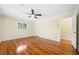 Bright bedroom features hardwood floors, ceiling fan and a sunny window at 4562 Anderson Livsey Ln, Snellville, GA 30039