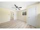 Inviting bedroom with wood-look laminate flooring, ceiling fan, and ample natural light throughout at 4562 Anderson Livsey Ln, Snellville, GA 30039