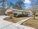 Single-story home boasts an attached garage and well-maintained landscaping at 4562 Anderson Livsey Ln, Snellville, GA 30039