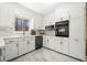 Kitchen featuring white cabinets, marble counters, and stainless steel appliances at 4562 Anderson Livsey Ln, Snellville, GA 30039