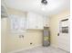 Laundry room with ample storage, cabinetry, and exterior access at 4562 Anderson Livsey Ln, Snellville, GA 30039