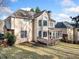 Tan two-story house with a wooden deck and a screened-in porch overlooking the yard at 5071 Vinings Estates Se Ct, Mableton, GA 30126