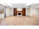 View of the basement with tiled floor, fireplace, built-in bookshelves, and large window at 5071 Vinings Estates Se Ct, Mableton, GA 30126