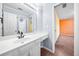 Bright bathroom featuring a single sink vanity adjacent to an opening for the bedroom at 5071 Vinings Estates Se Ct, Mableton, GA 30126
